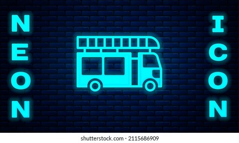Glowing neon Fire truck icon isolated on brick wall background. Fire engine. Firefighters emergency vehicle.  Vector