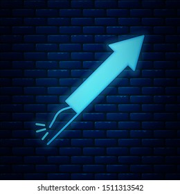 Glowing neon Firework rocket icon isolated on brick wall background. Concept of fun party. Explosive pyrotechnic symbol.  Vector Illustration