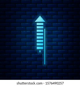 Glowing neon Firework rocket icon isolated on brick wall background. Concept of fun party. Explosive pyrotechnic symbol.  Vector Illustration