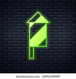 Glowing neon Firework rocket icon isolated on brick wall background. Concept of fun party. Explosive pyrotechnic symbol.  Vector