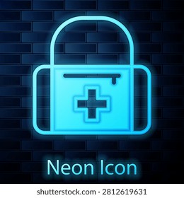 Glowing neon First aid kit icon isolated on brick wall background. Medical box with cross. Medical equipment for emergency. Healthcare concept.  Vector