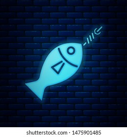 Glowing neon Fish on hook icon isolated on brick wall background.  Vector Illustration