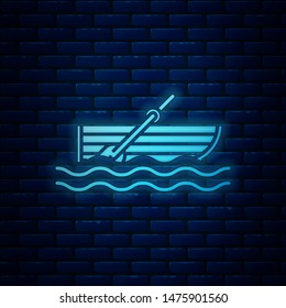 Glowing neon Fishing boat with oars on water icon isolated on brick wall background.  Vector Illustration