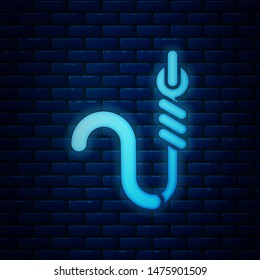 Glowing neon Fishing hook and worm icon isolated on brick wall background. Fishing tackle.  Vector Illustration