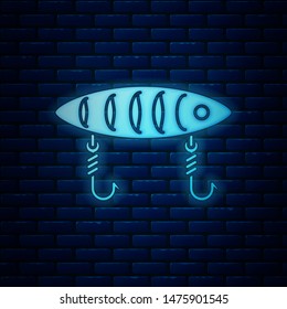 Glowing neon Fishing lure icon isolated on brick wall background. Fishing tackle.  Vector Illustration