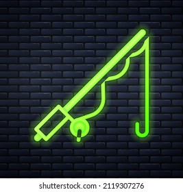 Glowing neon Fishing rod icon isolated on brick wall background. Catch a big fish. Fishing equipment and fish farming topics.  Vector