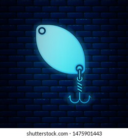 Glowing neon Fishing spoon icon isolated on brick wall background. Fishing baits in shape of fish. Fishing tackle.  Vector Illustration