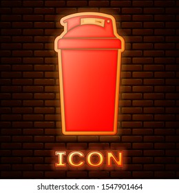 Glowing neon Fitness shaker icon isolated on brick wall background. Sports shaker bottle with lid for water and protein cocktails.  Vector Illustration