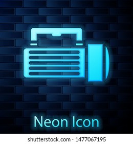 Glowing neon Flashlight icon isolated on brick wall background. Tourist flashlight handle.  Vector Illustration