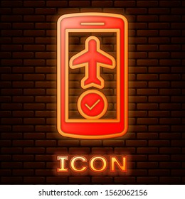 Glowing neon Flight mode in the mobile phone icon isolated on brick wall background. Airplane or aeroplane flight offline mode passenger regulation airline .  Vector Illustration