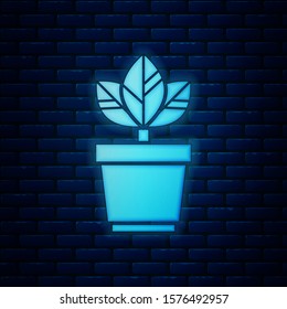 Glowing neon Flowers in pot icon isolated on brick wall background. Plant growing in a pot. Potted plant sign.  Vector Illustration