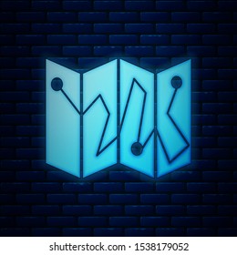 Glowing neon Folded map with location marker icon isolated on brick wall background.  Vector Illustration