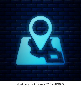 Glowing neon Folded map with location marker icon isolated on brick wall background.  Vector
