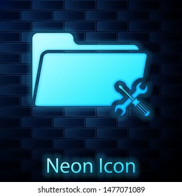 Glowing neon Folder with screwdriver and wrench icon isolated on brick wall background. Adjusting, service, setting, maintenance, repair, fixing.  Vector Illustration