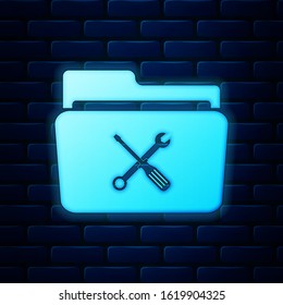 Glowing neon Folder and tools or settings icon isolated on brick wall background. Folder with wrench and screwdriver sign. Computer technical service.  Vector Illustration