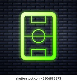 Glowing neon Football or soccer field icon isolated on brick wall background.  Vector