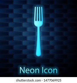 Glowing neon Fork icon isolated on brick wall background. Cutlery symbol.  Vector Illustration