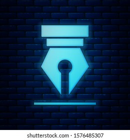 Glowing neon Fountain pen nib icon isolated on brick wall background. Pen tool sign.  Vector Illustration