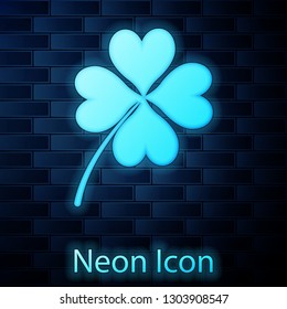 Glowing neon Four leaf clover icon isolated on brick wall background. Happy Saint Patrick day. Vector Illustration