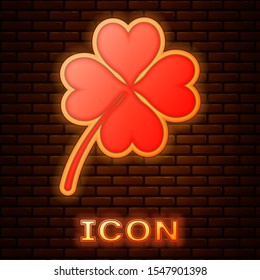 Glowing neon Four leaf clover icon isolated on brick wall background. Happy Saint Patrick day.  Vector Illustration