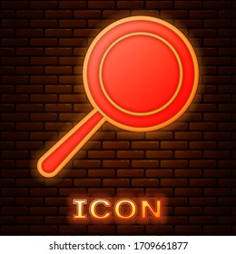 Glowing neon Frying pan icon isolated on brick wall background. Fry or roast food symbol. Vector Illustration