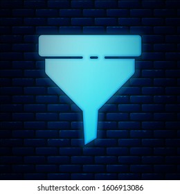 Glowing neon Funnel or filter icon isolated on brick wall background.  Vector Illustration