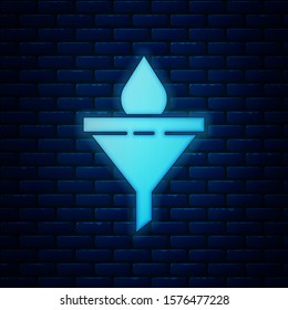 Glowing neon Funnel or filter and motor oil drop icon isolated on brick wall background.  Vector Illustration