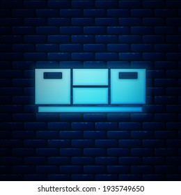 Glowing neon Furniture nightstand icon isolated on brick wall background.  Vector