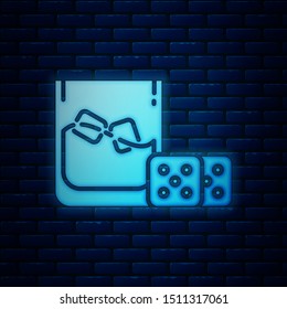 Glowing neon Game dice and glass of whiskey with ice cubes icon isolated on brick wall background. Casino gambling.  Vector Illustration