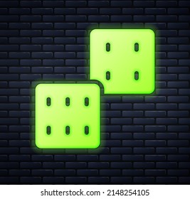 Glowing neon Game dice icon isolated on brick wall background. Casino gambling.  Vector