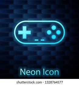 Glowing neon Gamepad icon isolated on brick wall background. Game controller. Vector Illustration