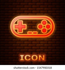 Glowing neon Gamepad icon isolated on brick wall background. Game controller.  Vector Illustration