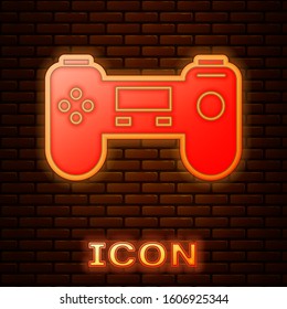 Glowing neon Gamepad icon isolated on brick wall background. Game controller.  Vector Illustration