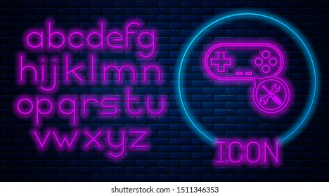 Glowing neon Gamepad with screwdriver and wrench icon isolated on brick wall background. Adjusting, service, setting, maintenance, repair, fixing. Neon light alphabet. Vector Illustration