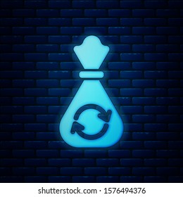 Glowing neon Garbage bag with recycle symbol icon isolated on brick wall background. Trash can icon. Recycle basket sign.  Vector Illustration