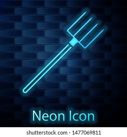 Glowing neon Garden pitchfork icon isolated on brick wall background. Garden fork sign. Tool for horticulture, agriculture, farming.  Vector Illustration