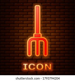 Glowing neon Garden pitchfork icon isolated on brick wall background. Garden fork sign. Tool for horticulture, agriculture, farming. Vector