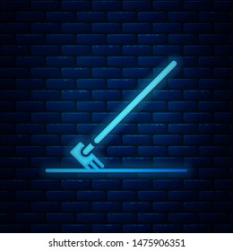 Glowing neon Garden rake in work icon isolated on brick wall background. Tool for horticulture, agriculture, farming. Ground cultivator.  Vector Illustration