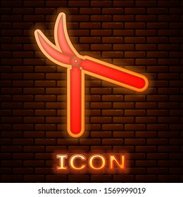 Glowing neon Gardening handmade scissors for trimming icon isolated on brick wall background. Pruning shears with wooden handles.  Vector Illustration