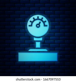 Glowing neon Gauge scale icon isolated on brick wall background. Satisfaction, temperature, manometer, risk, rating, performance, speed tachometer.  Vector Illustration