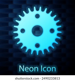 Glowing neon Gear icon isolated on brick wall background. Cogwheel gear settings sign. Cog symbol.  Vector