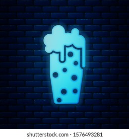 Glowing neon Glass of beer icon isolated on brick wall background.  Vector Illustration