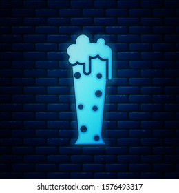 Glowing neon Glass of beer icon isolated on brick wall background.  Vector Illustration
