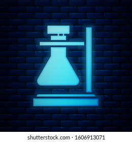 Glowing neon Glass test tube flask on stand icon isolated on brick wall background. Laboratory equipment.  Vector Illustration