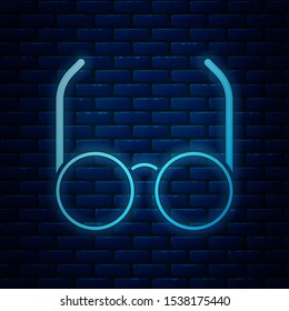 Glowing neon Glasses icon isolated on brick wall background. Eyeglass frame symbol.  Vector Illustration