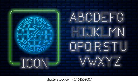 Glowing neon Globe with flying plane icon isolated on brick wall background. Airplane fly around the planet earth. Aircraft world icon. Neon light alphabet. Vector Illustration