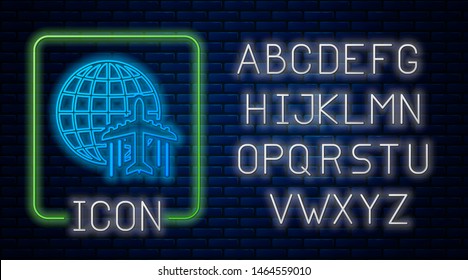 Glowing neon Globe with flying plane icon isolated on brick wall background. Airplane fly around the planet earth. Aircraft world icon. Neon light alphabet. Vector Illustration