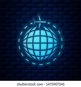 Glowing neon Globe with flying plane icon isolated on brick wall background. Airplane fly around the planet earth. Aircraft world icon.  Vector Illustration