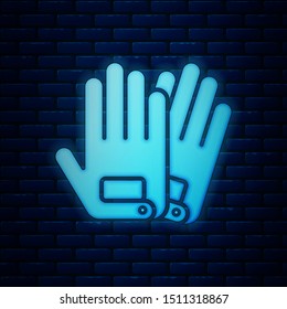 Glowing neon Gloves icon isolated on brick wall background. Extreme sport. Sport equipment.  Vector Illustration
