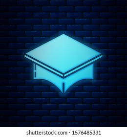 Glowing neon Graduation cap icon isolated on brick wall background. Graduation hat with tassel icon.  Vector Illustration